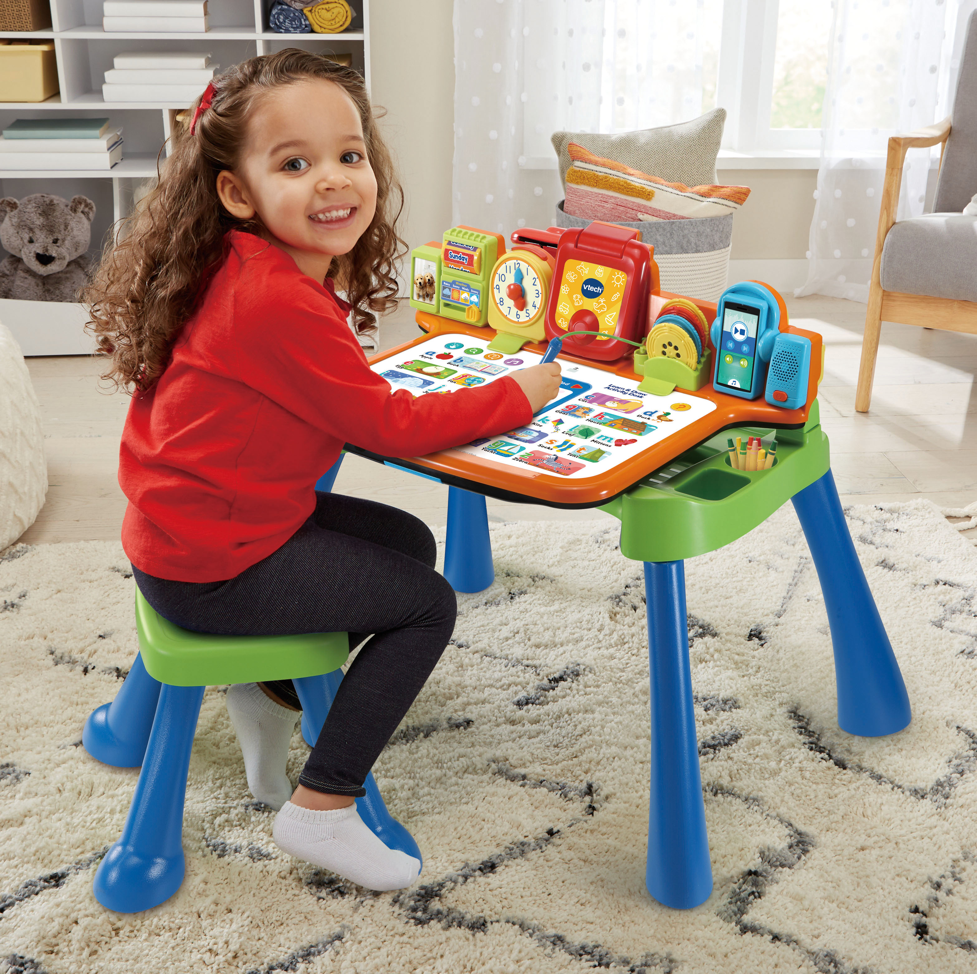 5-in-1 learning desk with stool includes an interactive desktop, projector, LED writing pad with stylus, chalk board and art station.